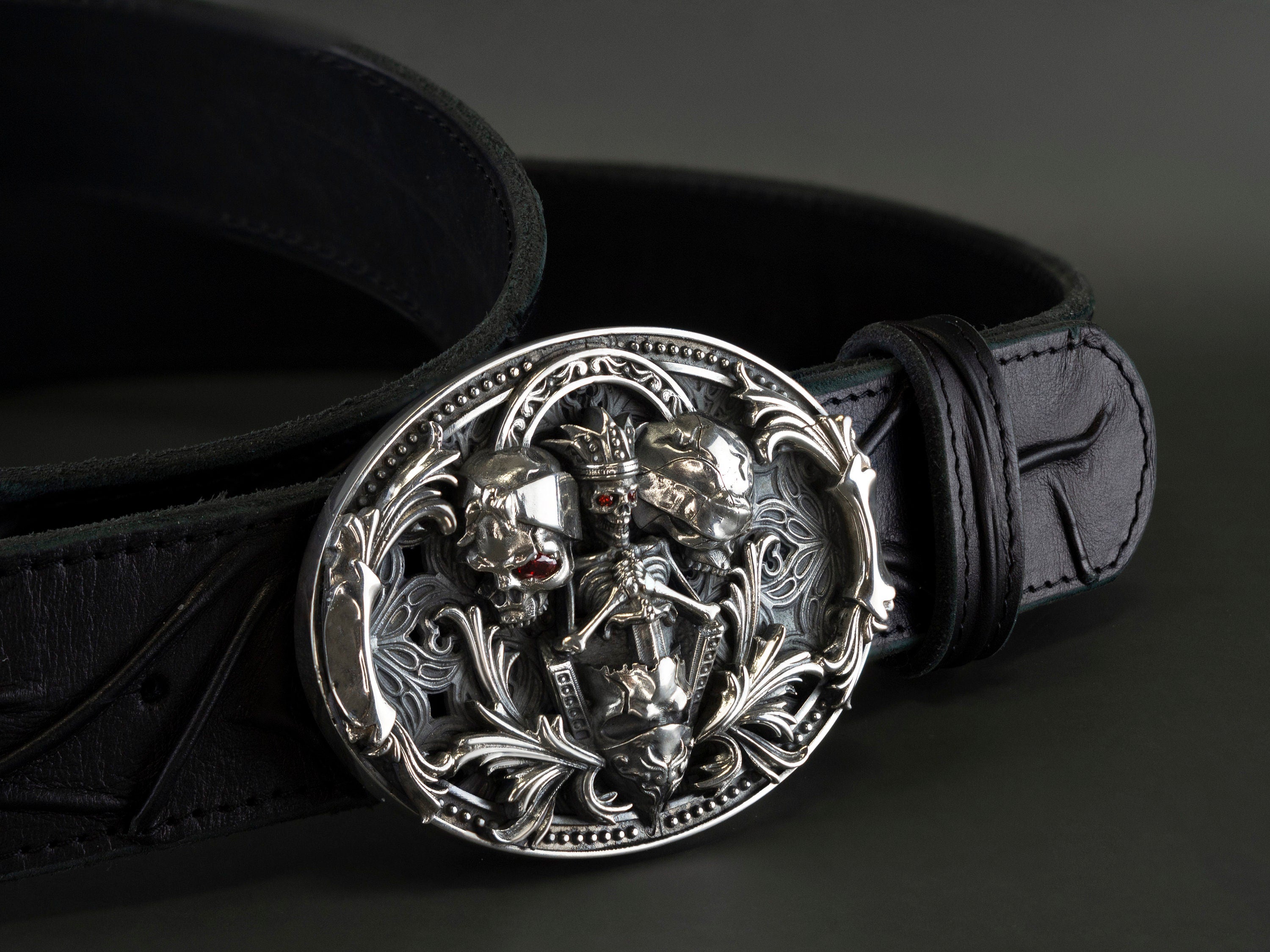 Hear Nothing See Nothing buckle detail with red stone accents