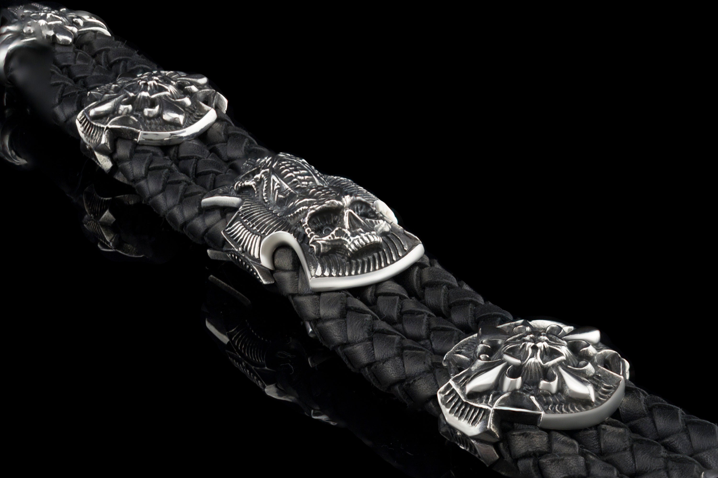 Heavy sterling silver skull bracelet on black braided leather, detail