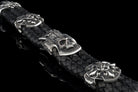 Heavy sterling silver skull bracelet on black braided leather, detail