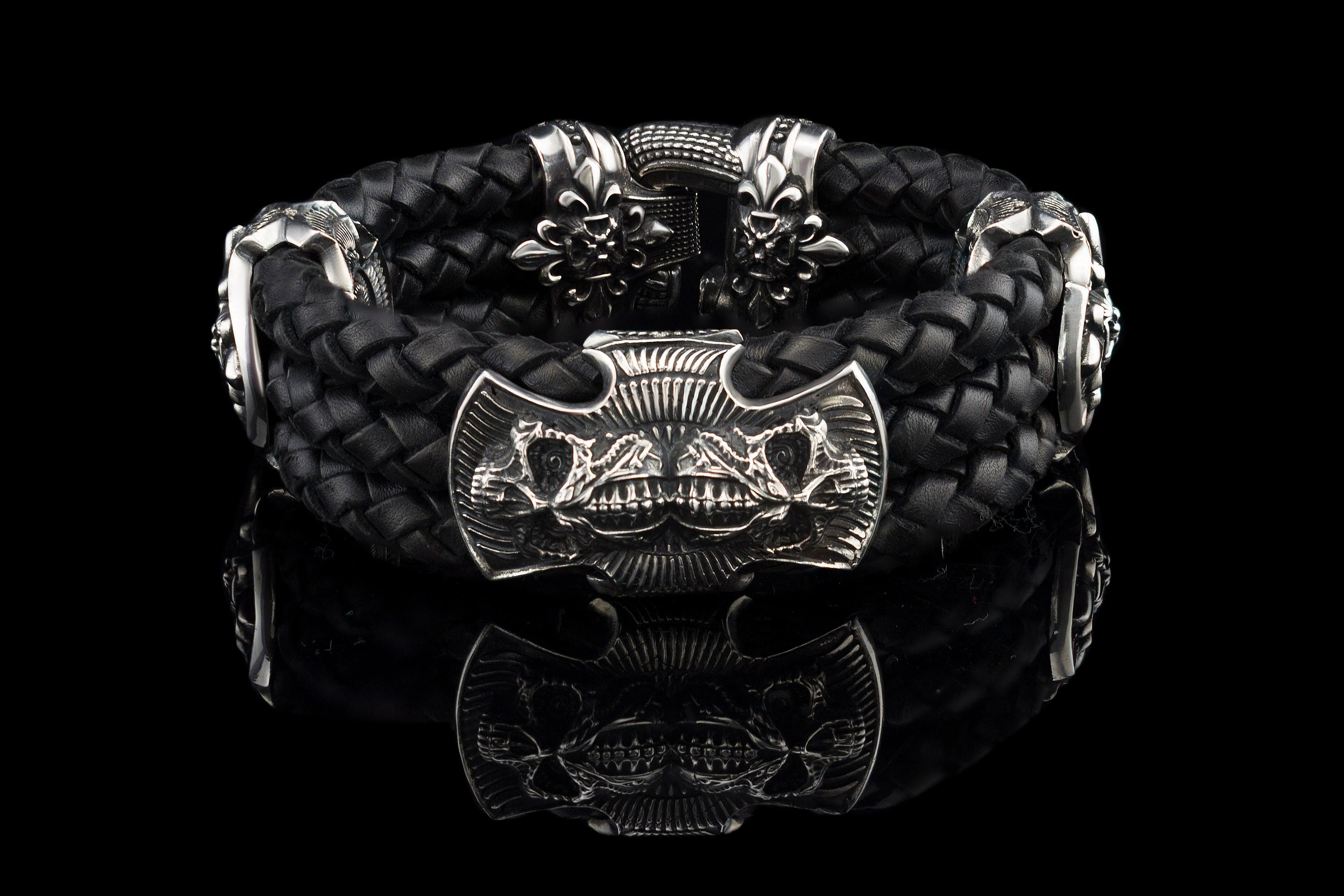 Heavy sterling silver skull bracelet on black braided leather, front