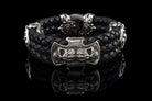 Heavy sterling silver skull bracelet on black braided leather, front