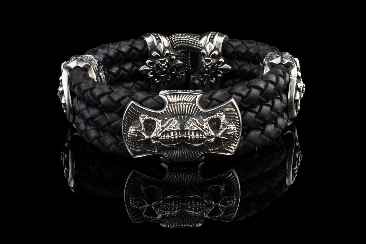 Heavy sterling silver skull bracelet on black braided leather, front