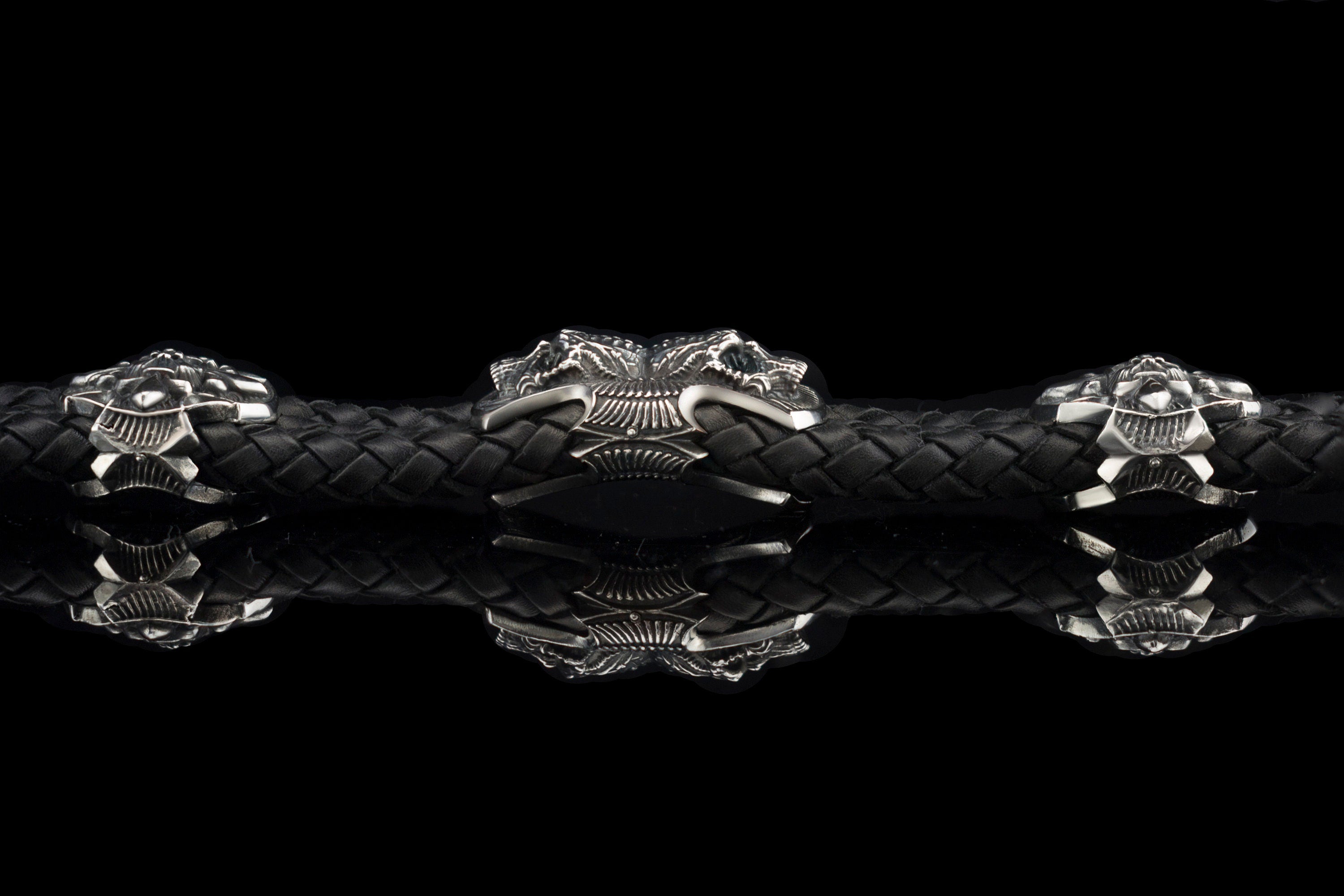 Heavy sterling silver skull bracelet on black braided leather, straight 2