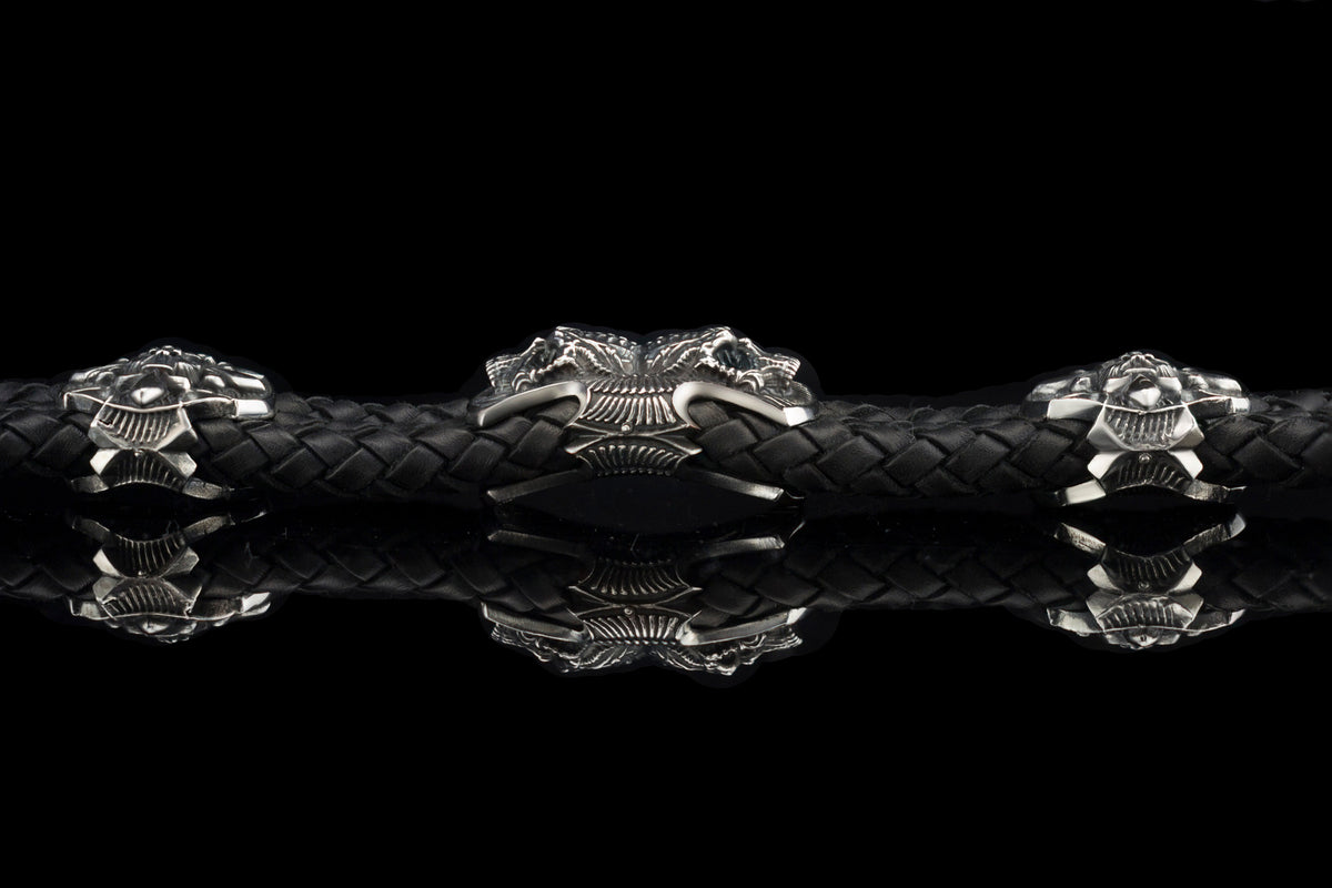 Heavy sterling silver skull bracelet on black braided leather, straight 2