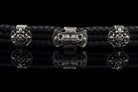 Heavy sterling silver skull bracelet on black braided leather, straight