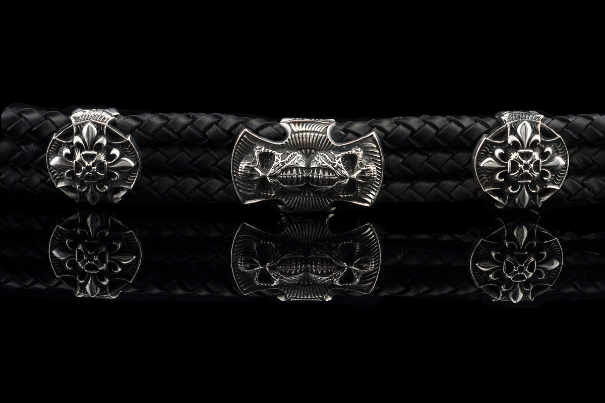 Heavy sterling silver skull bracelet on black braided leather, straight
