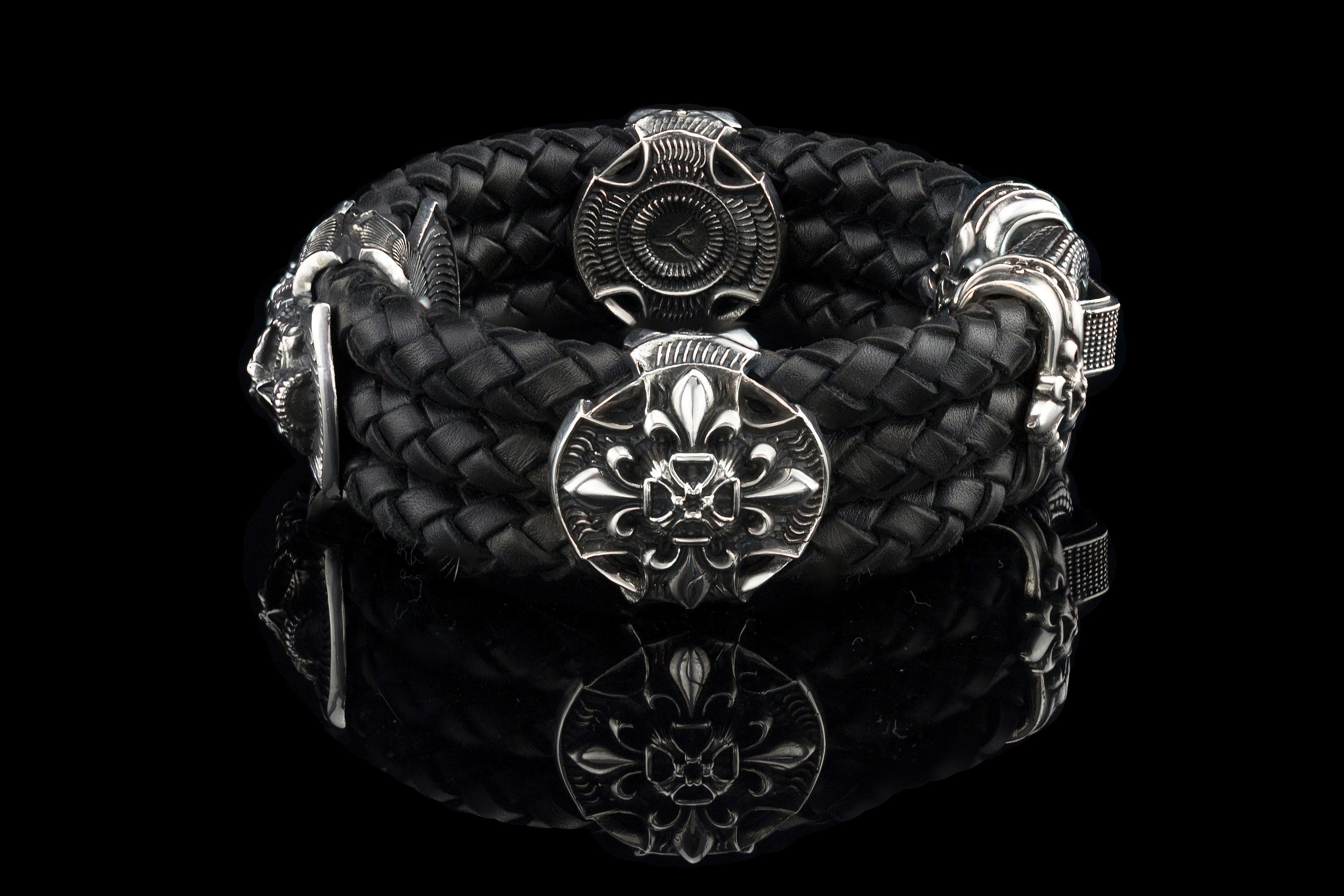 Heavy sterling silver skull bracelet on black braided leather, top