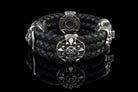 Heavy sterling silver skull bracelet on black braided leather, top