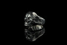 Hellbound skull biker ring, left side view showing cracked texture and smooth inner band