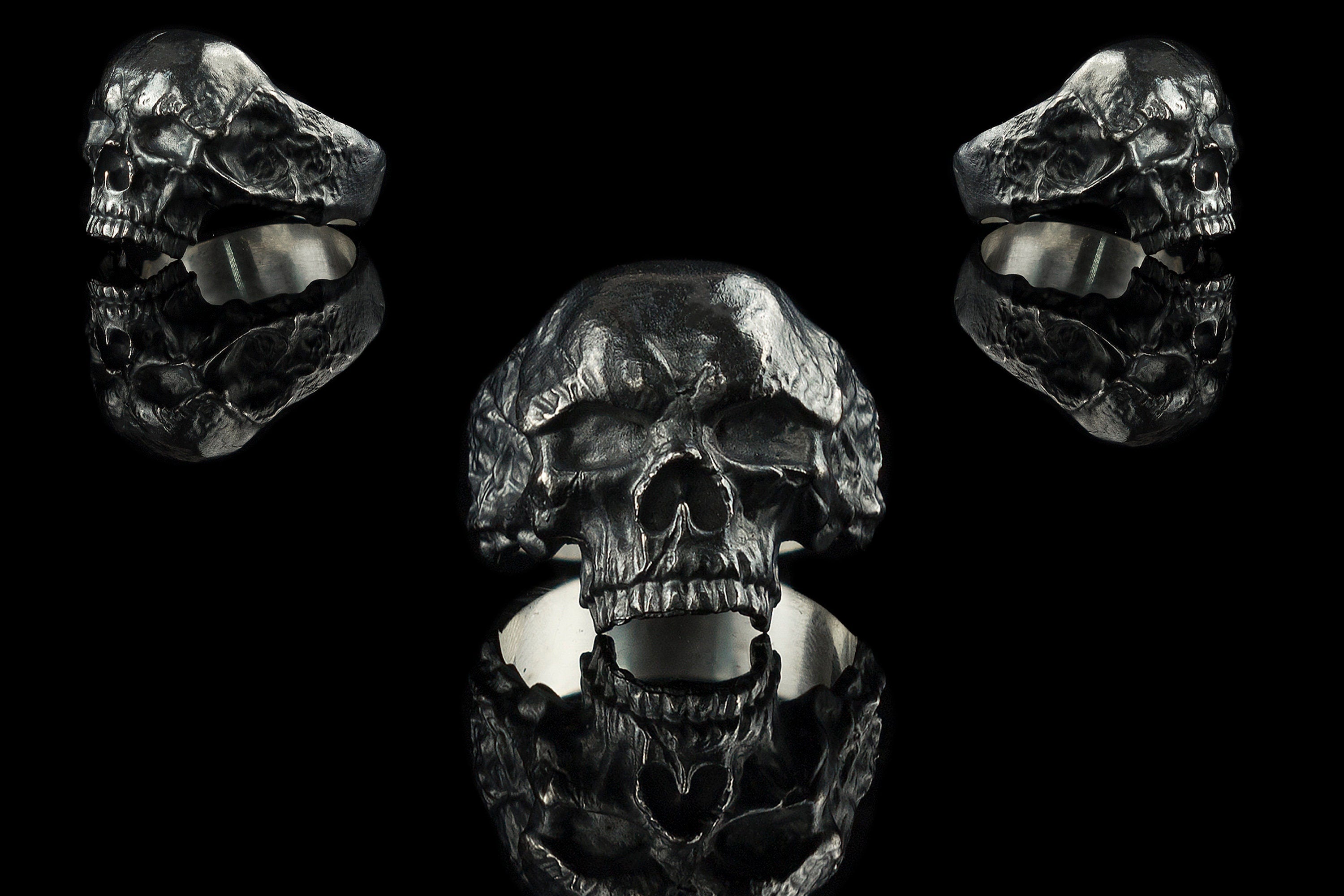 Hellbound sterling silver skull ring shown from front and both sides on black