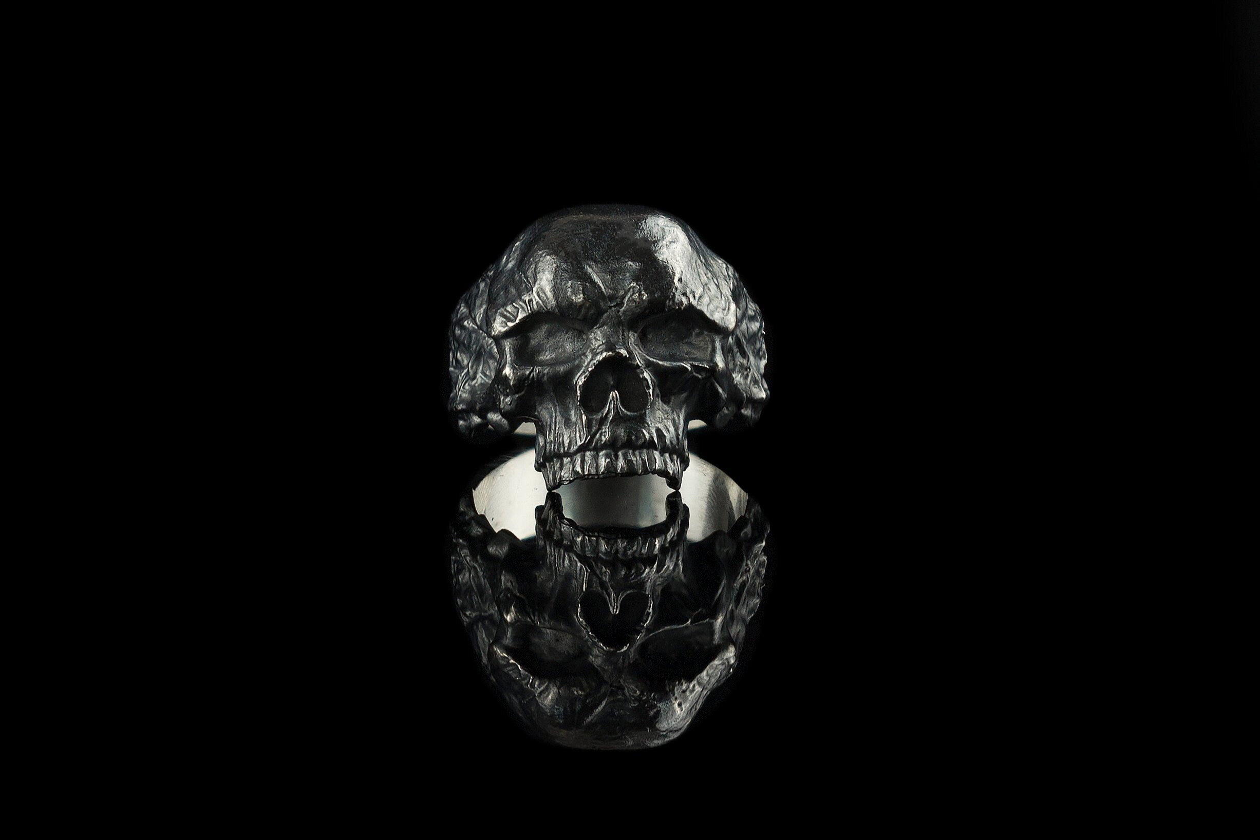 Hellbound sterling silver skull ring, front view of the open-jaw skull with darkened weathered texture