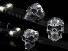 Biomechanical sterling silver skull ring shown from three angles on black background