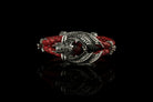 The Dragon Heart bracelet by Yeti Jewelry features an intricate dragon-inspired centerpiece crafted from 925 sterling silver, a red garnet gemstone and a braided red leather cord. The bracelet measures 18 cm long and 26 mm wide, with an approximate weight of 45 grams. Custom lengths and alternative gemstone options are available upon request.