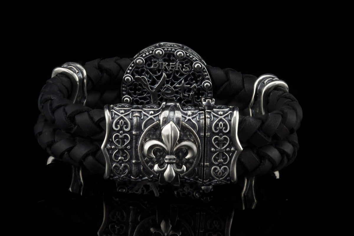 Crowned skull bracelet with 925 sterling silver details, genuine black braided leather and red cubic zirconia eyes