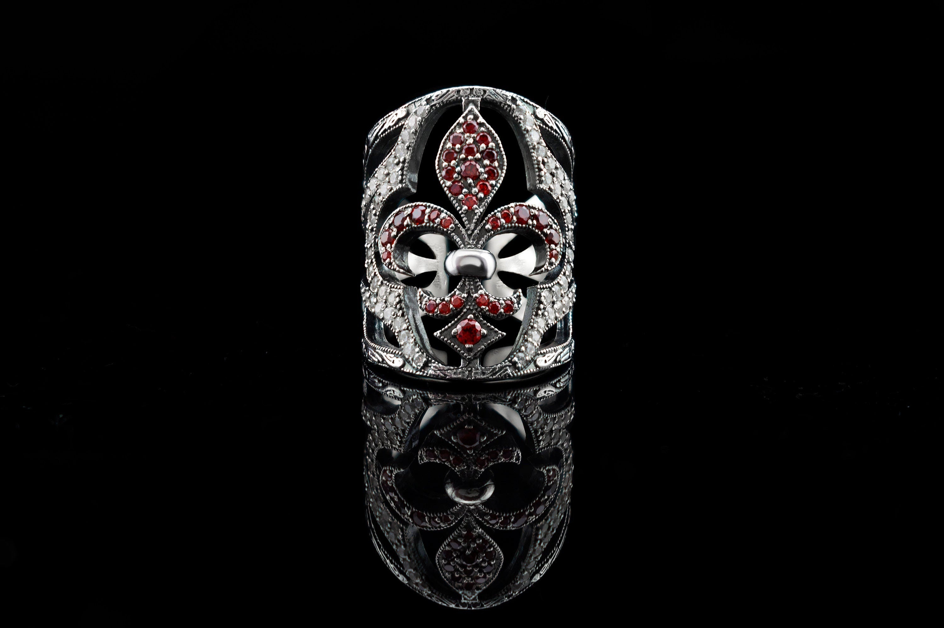 Handcrafted 925 sterling silver "Mary" wide band ring featuring a Fleur-de-Lis set with ruby red and clear pave cubic zirconia stones