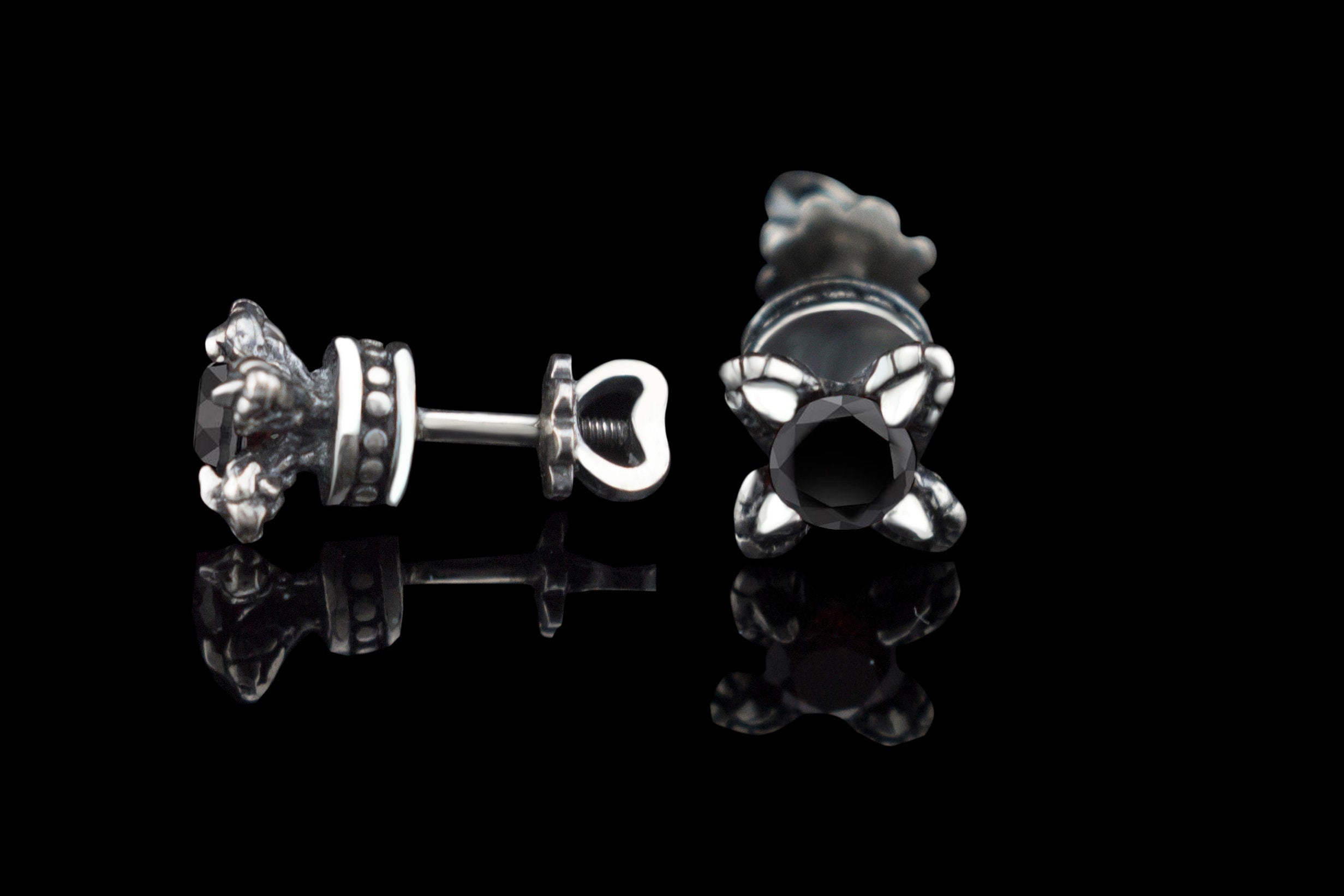 Handcrafted 925 sterling silver "Giona" stud earrings featuring sapphire blue cubic zirconia stones in sculpted claw settings with screw-back closures


