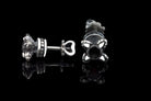 Handcrafted 925 sterling silver "Giona" stud earrings featuring sapphire blue cubic zirconia stones in sculpted claw settings with screw-back closures


