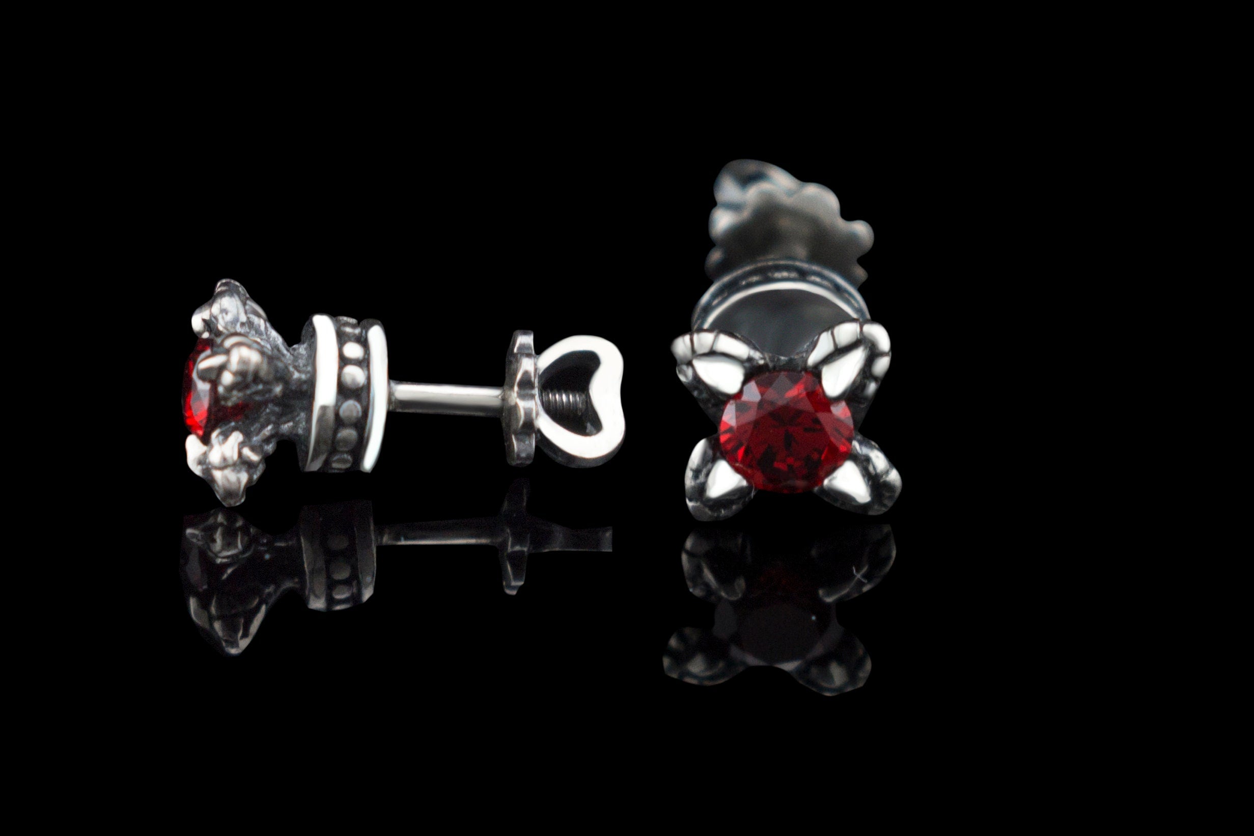 Handcrafted 925 sterling silver "Giona" stud earrings featuring sapphire blue cubic zirconia stones in sculpted claw settings with screw-back closures


