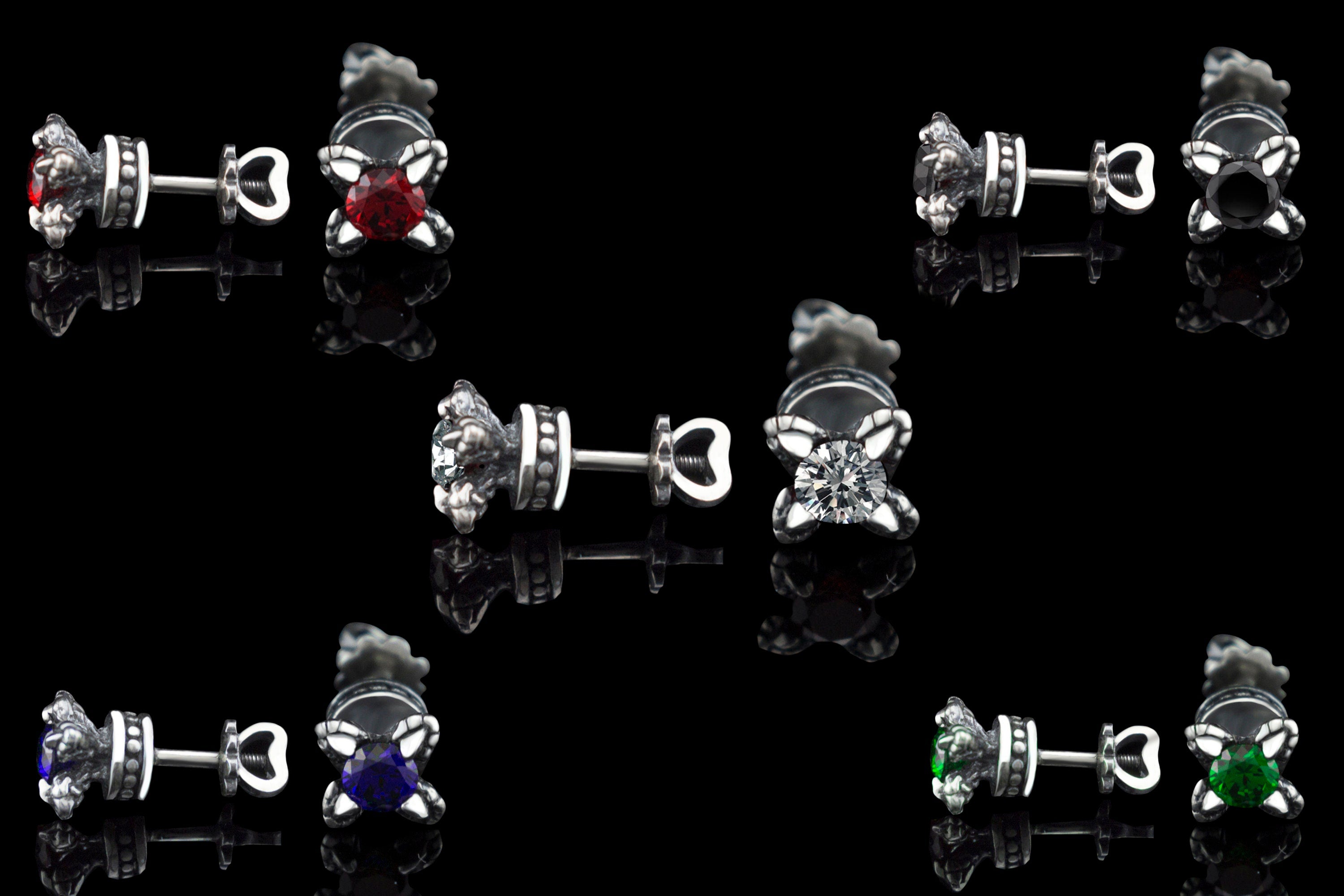 Handcrafted 925 sterling silver "Giona" stud earrings featuring sapphire blue cubic zirconia stones in sculpted claw settings with screw-back closures


