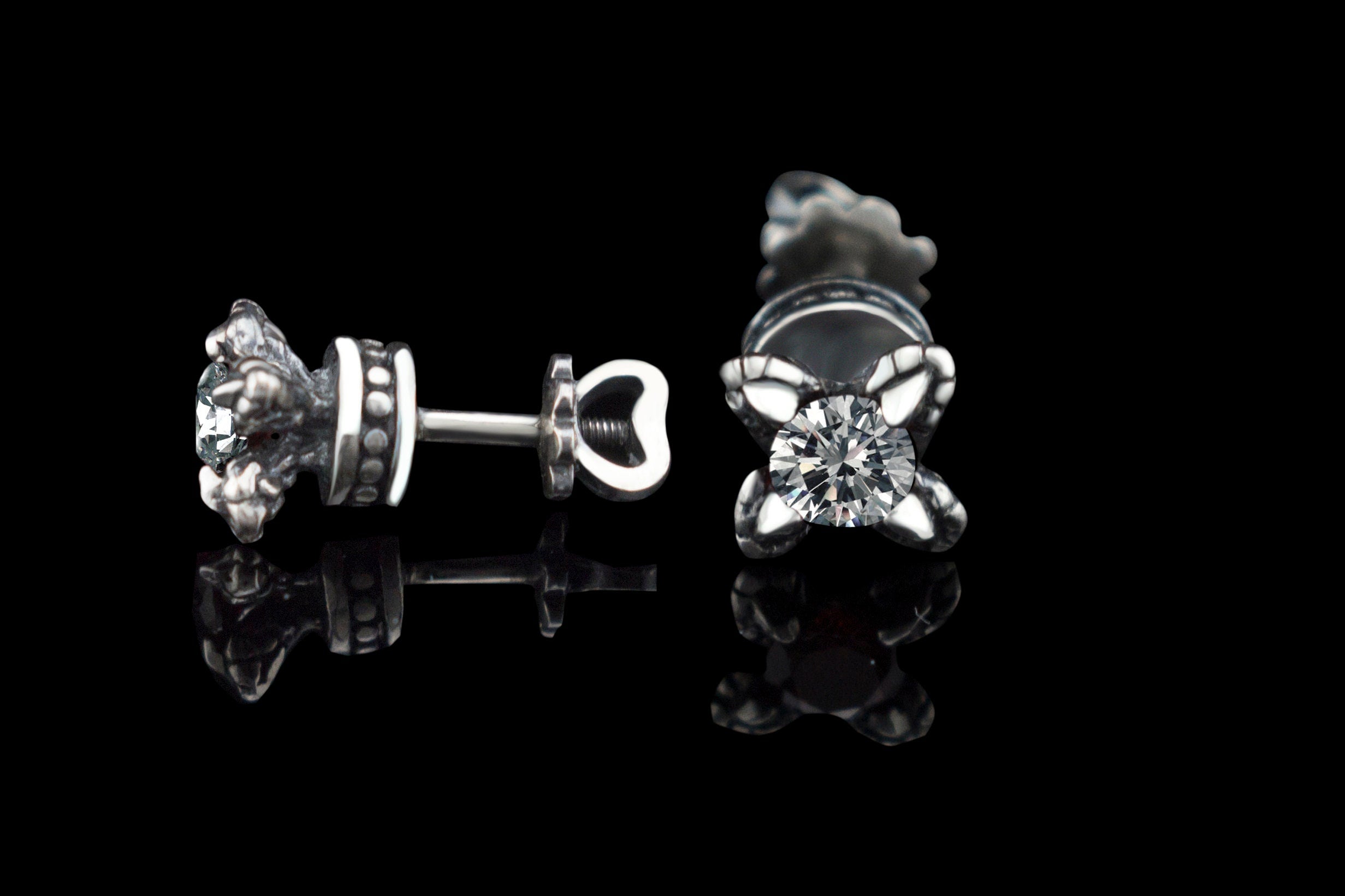 Handcrafted 925 sterling silver "Giona" stud earrings featuring sapphire blue cubic zirconia stones in sculpted claw settings with screw-back closures



