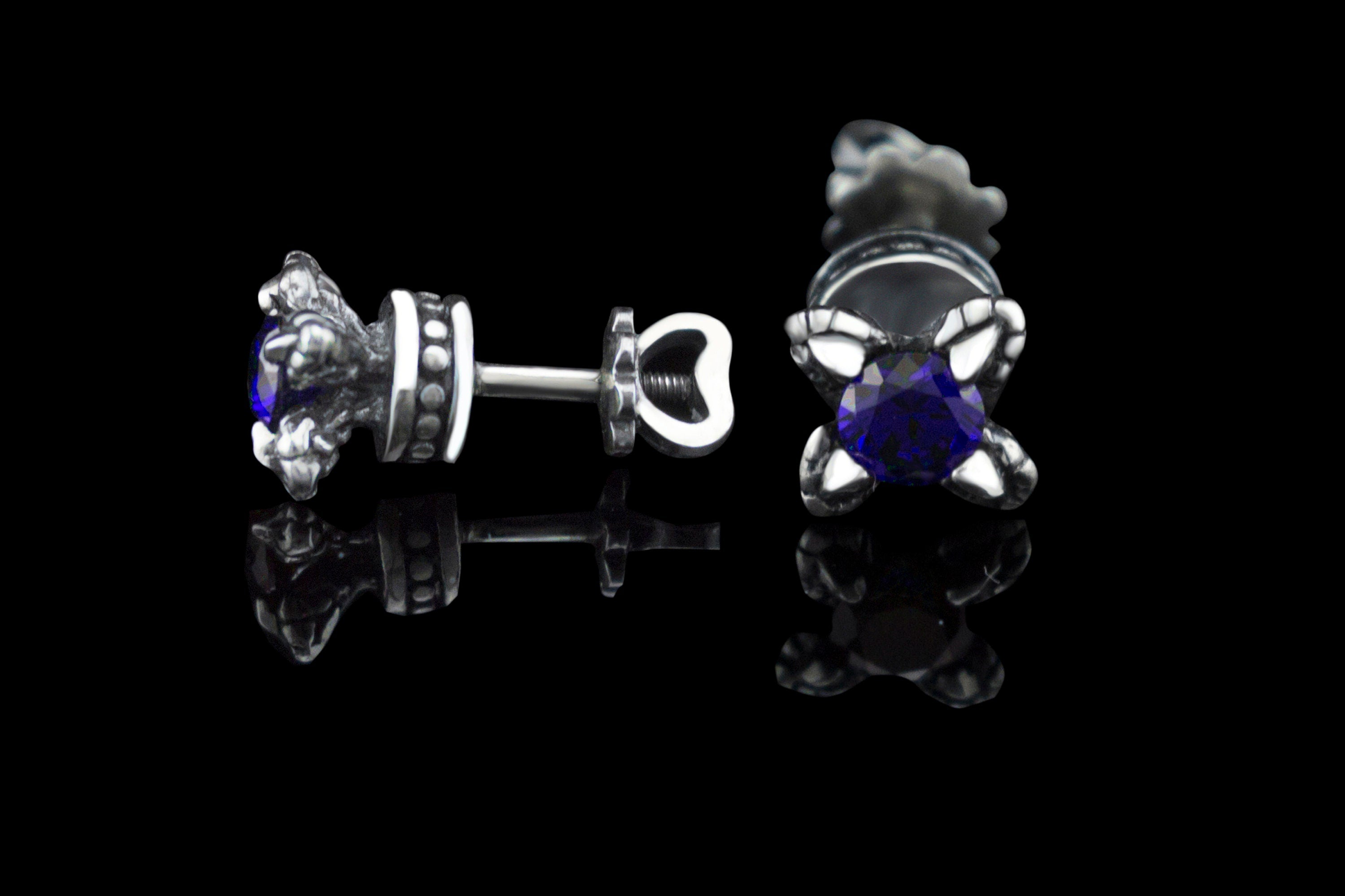 Handcrafted 925 sterling silver "Giona" stud earrings featuring sapphire blue cubic zirconia stones in sculpted claw settings with screw-back closures


