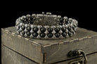 The Saint Victor bracelet by Yeti Jewelry features polished black onyx beads, intricately detailed sterling silver elements, and a prominent decorative central motif. This approximately 75-gram statement bracelet is handcrafted in 925 sterling silver and can be custom-made to the requested wrist size.