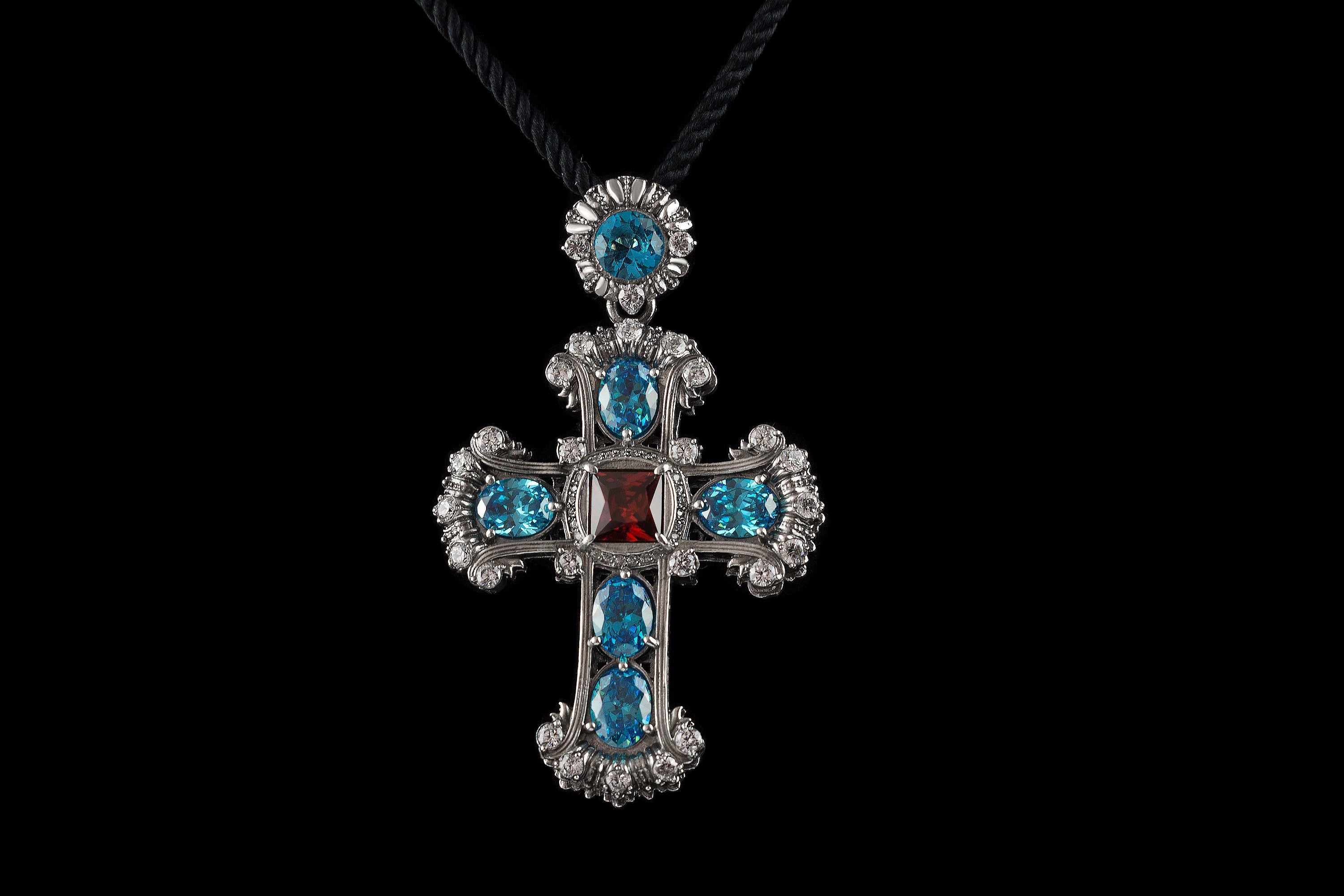Gothic Victorian sterling silver cross pendant with blue and red stones on black cord