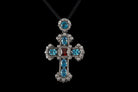 Gothic Victorian sterling silver cross pendant with blue and red stones on black cord