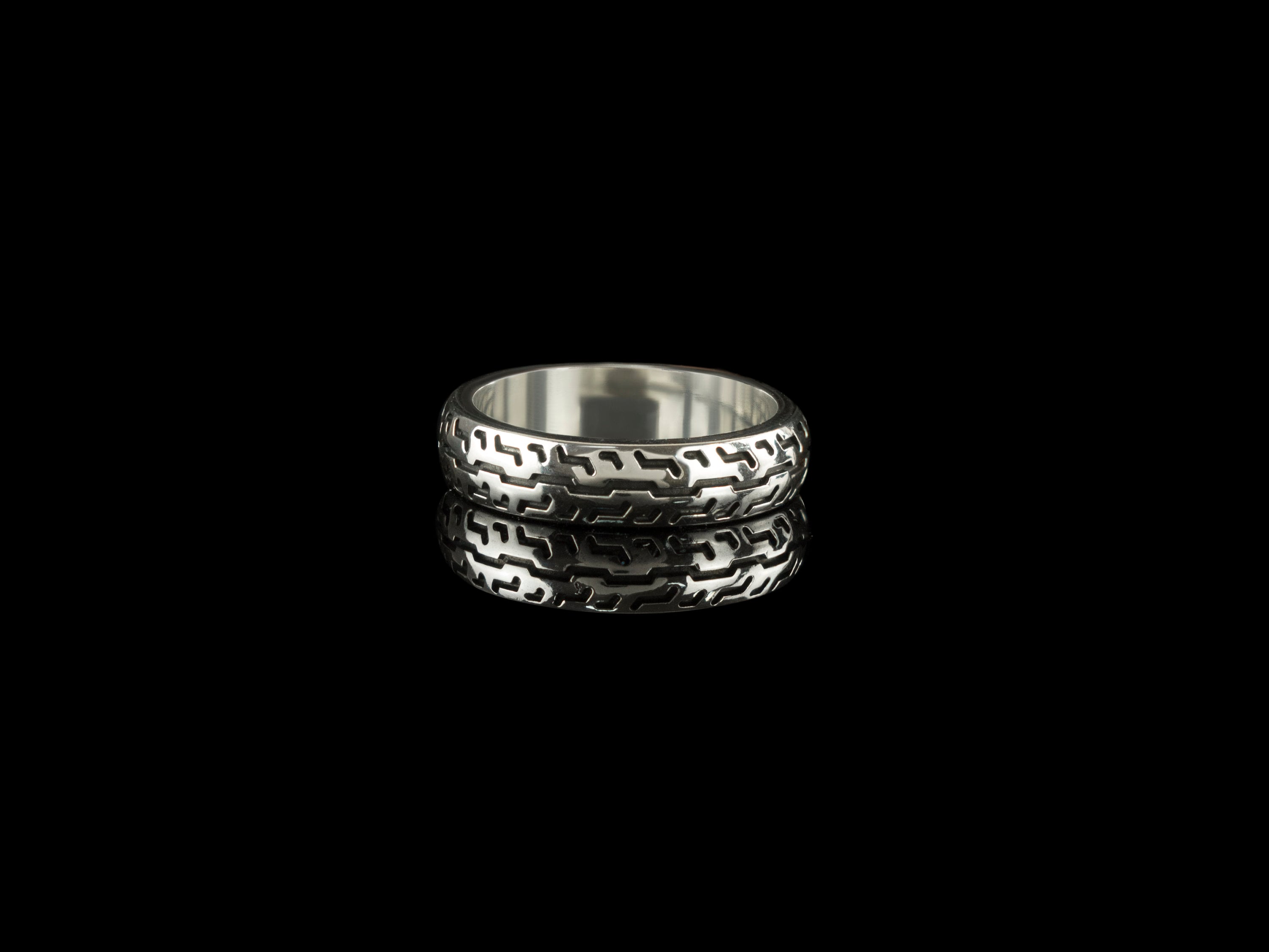 925 sterling silver motorcycle tire ring with deep geometric tread pattern and polished inner band