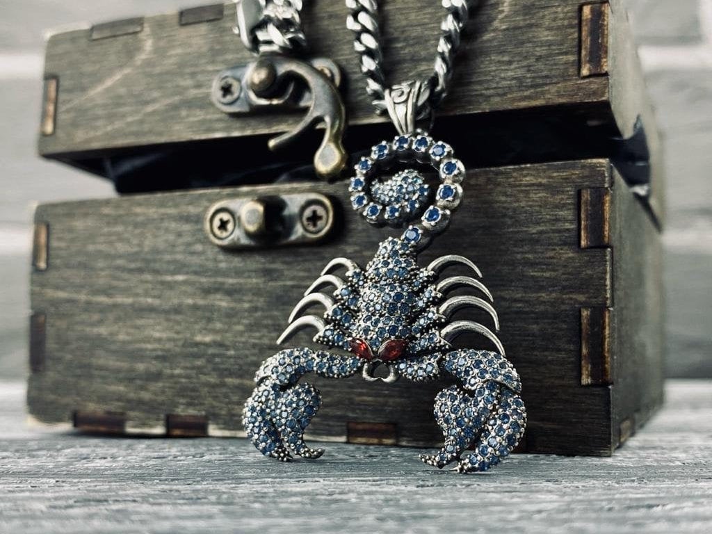 Scorpion Emperor Blue 925 sterling silver pendant with blue cubic zirconia stones, red eye accents, sculpted claws, and curved tail.