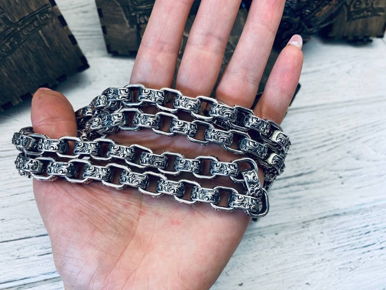 Rory heavy 925 sterling silver chain necklace with ornate interlocking links and oxidized detailing, displayed across a hand to show its scale.