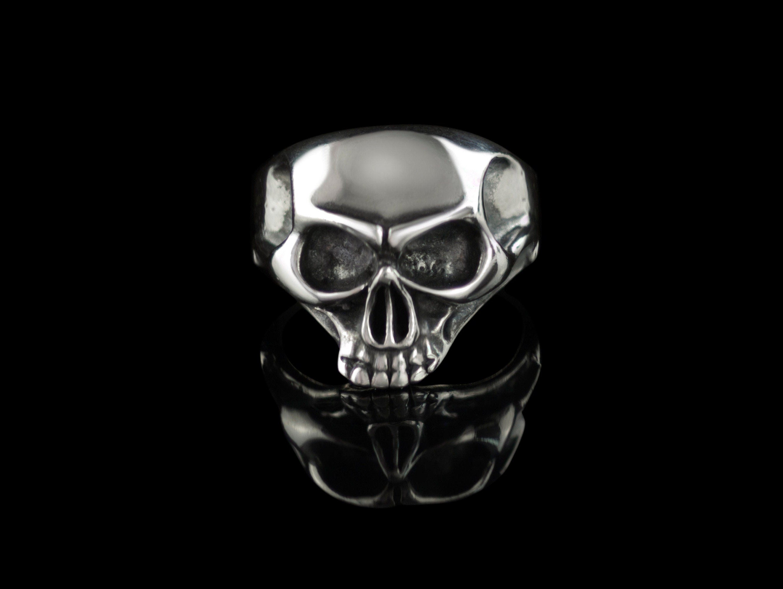 Beliar gothic skull ring handcrafted from 925 sterling silver with polished skull details, photographed against a black background.