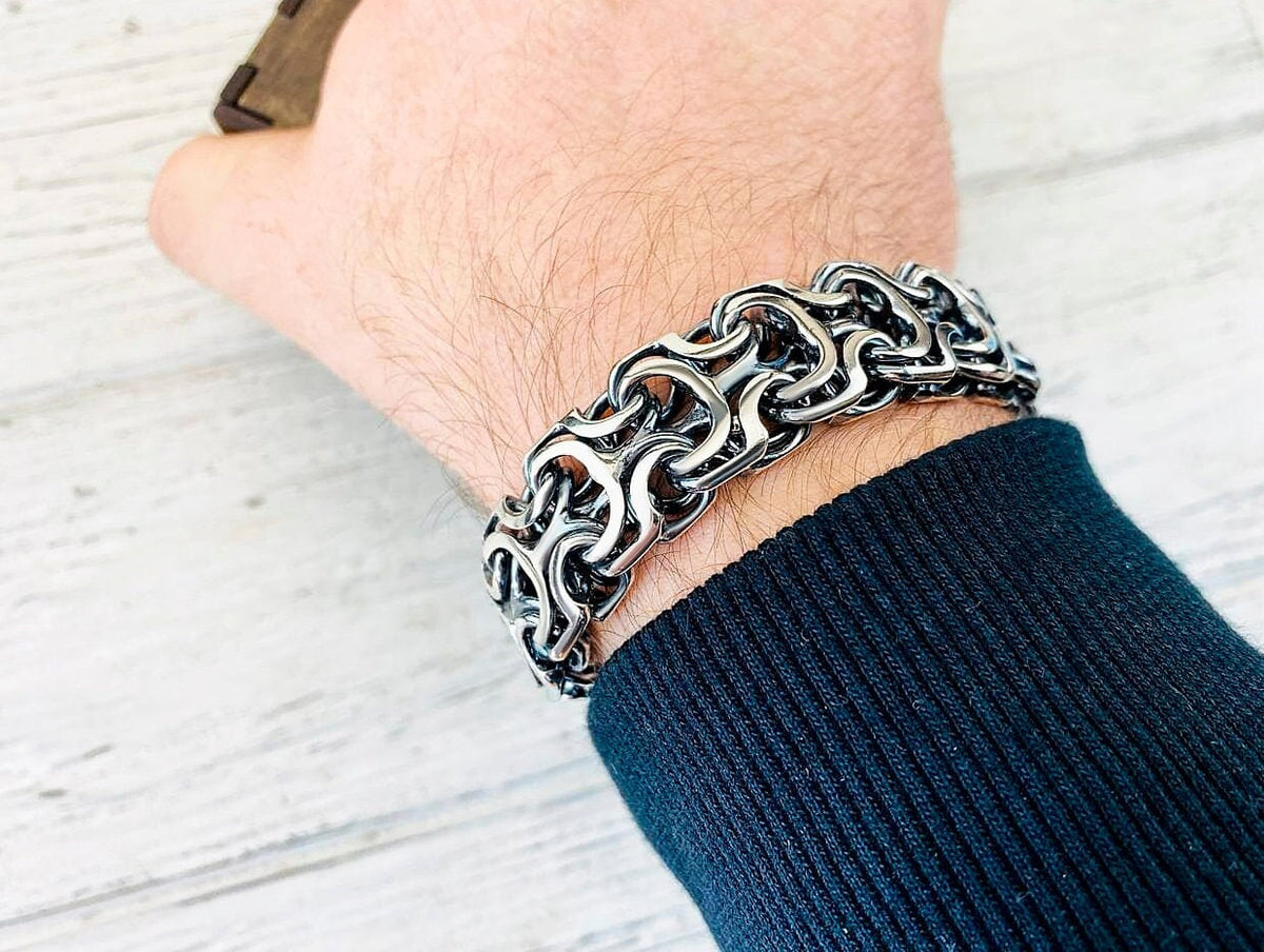Heavy 925 sterling silver bracelet with intricate interlocking sculptural links, approximately 19 mm wide