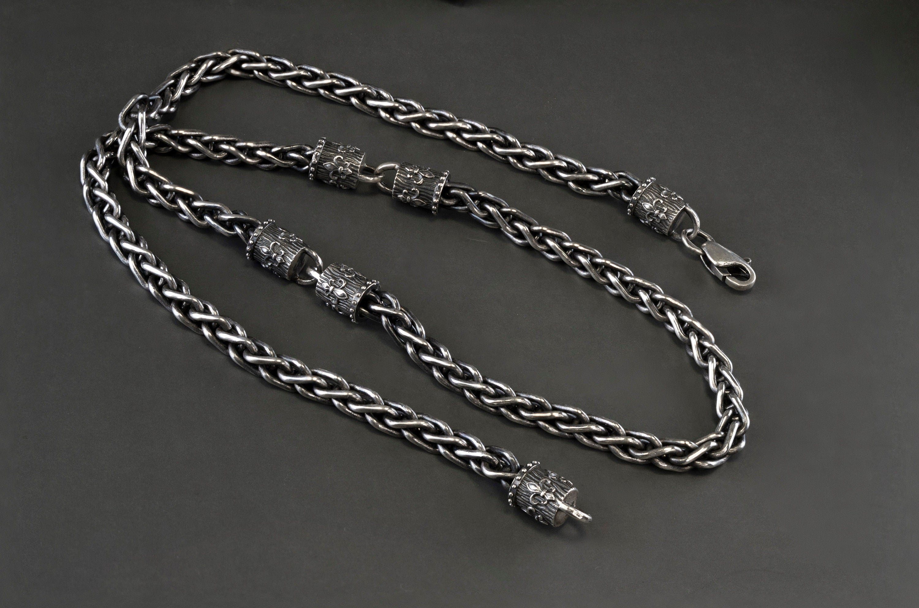 Heavy Fleur de Lis wheat chain necklace in 925 sterling silver with a 6.5 mm woven chain and ornate decorative end pieces, displayed on a wooden Yeti Jewelry box.