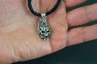 Emeric small 925 sterling silver skull pendant with sculpted flame-like details and polished highlights, displayed on a black cord.