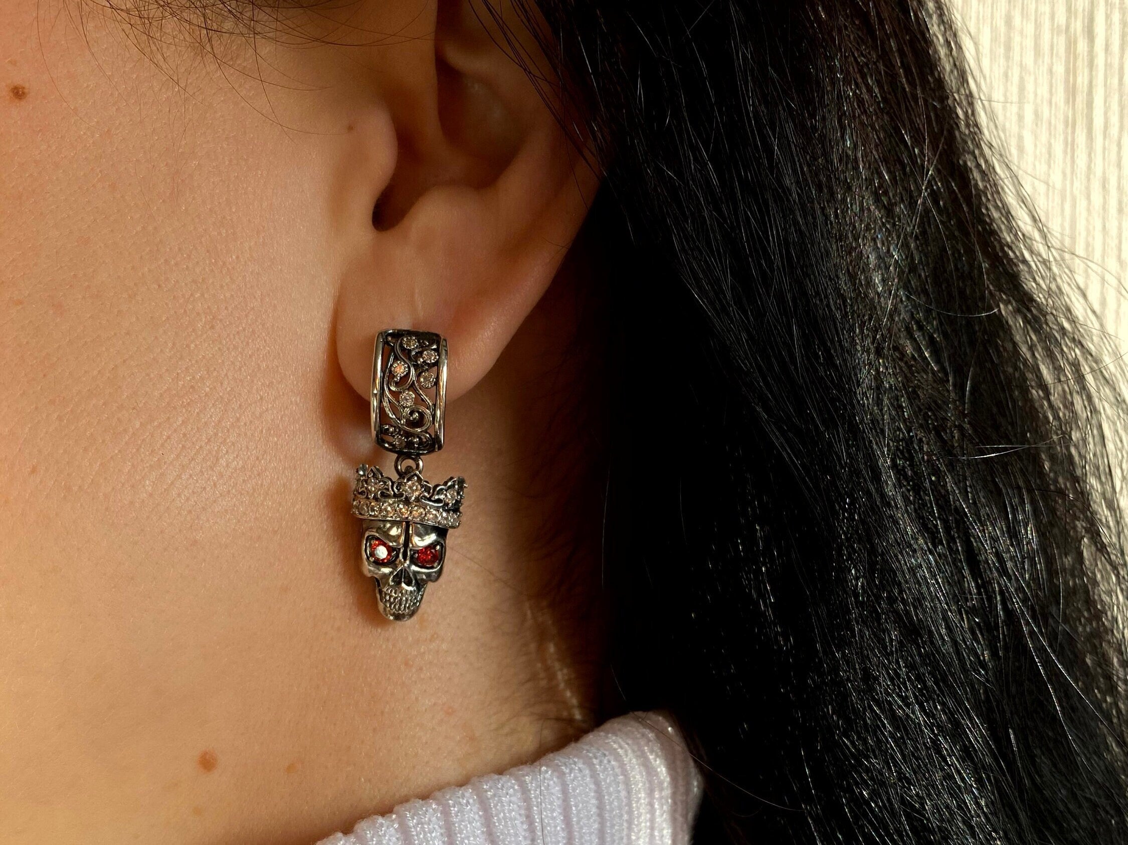 Santa Muerte-inspired 925 sterling silver skull earrings with crowned skulls and deep red cubic zirconia eyes