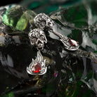 Furious Bonnie skull ring in 925 sterling silver with red cubic zirconia stones and sculpted flame details by Yeti Jewelry
