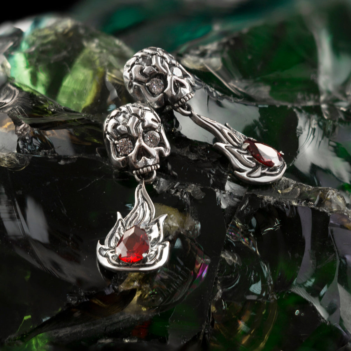 Furious Bonnie skull ring in 925 sterling silver with red cubic zirconia stones and sculpted flame details by Yeti Jewelry