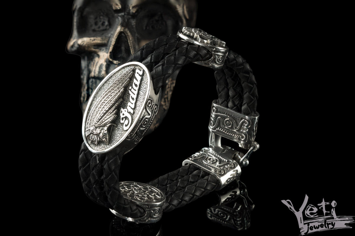 Indian Chief leather bracelet with a braided leather band, 925 sterling silver ornamental fittings, and an oval feather headdress centerpiece.