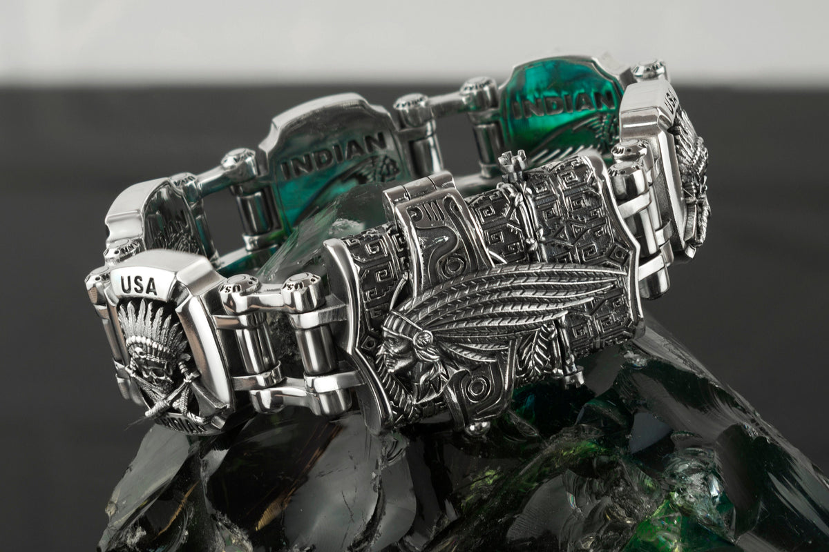 Indian bracelet resting on a rock, feather headdress motif detail