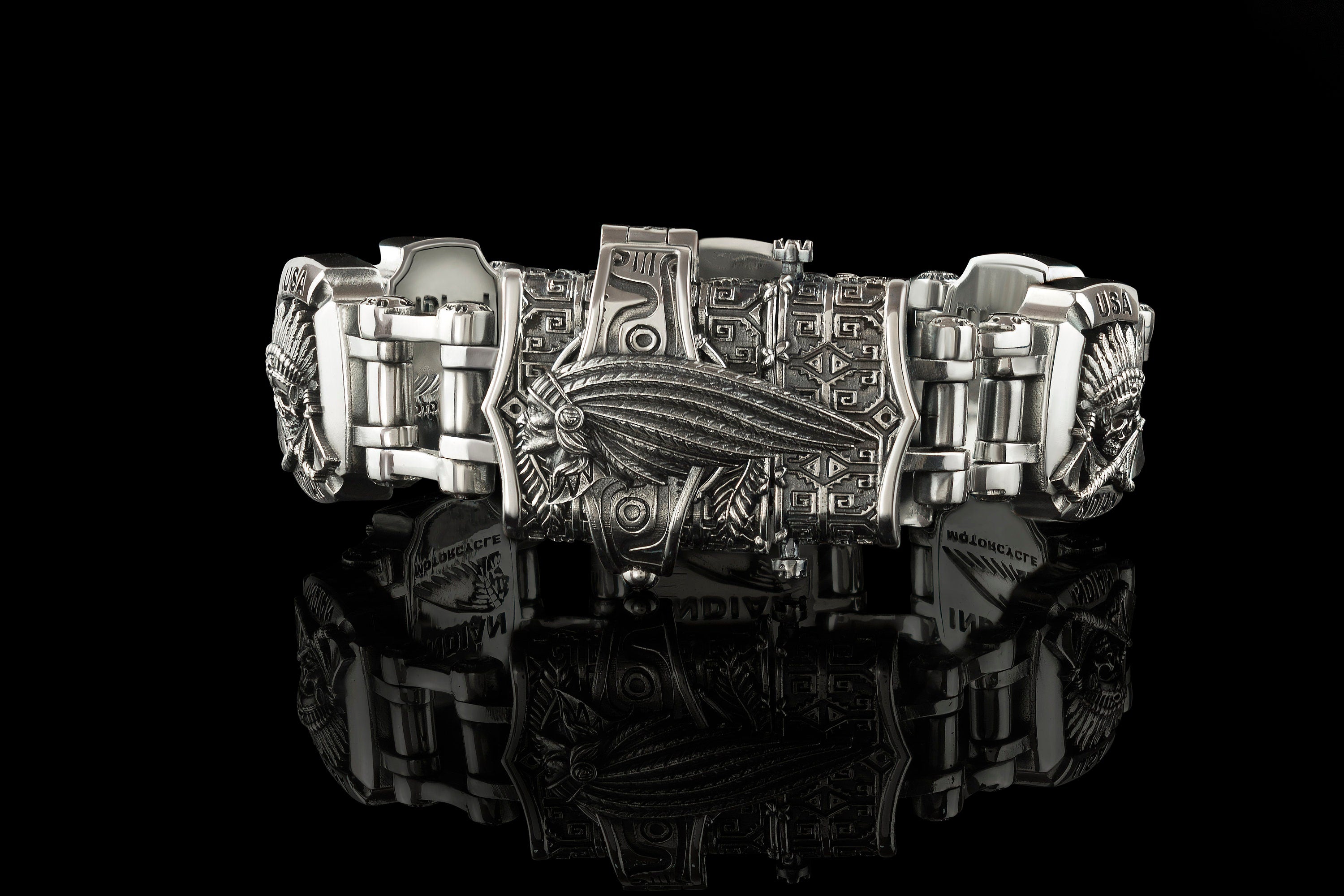 Close-up of the INDIAN lettering plate on the heavy silver bracelet