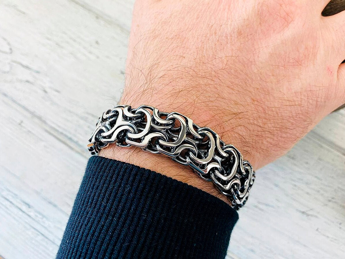 Kardinal heavy bracelet on the wrist with a navy sweater