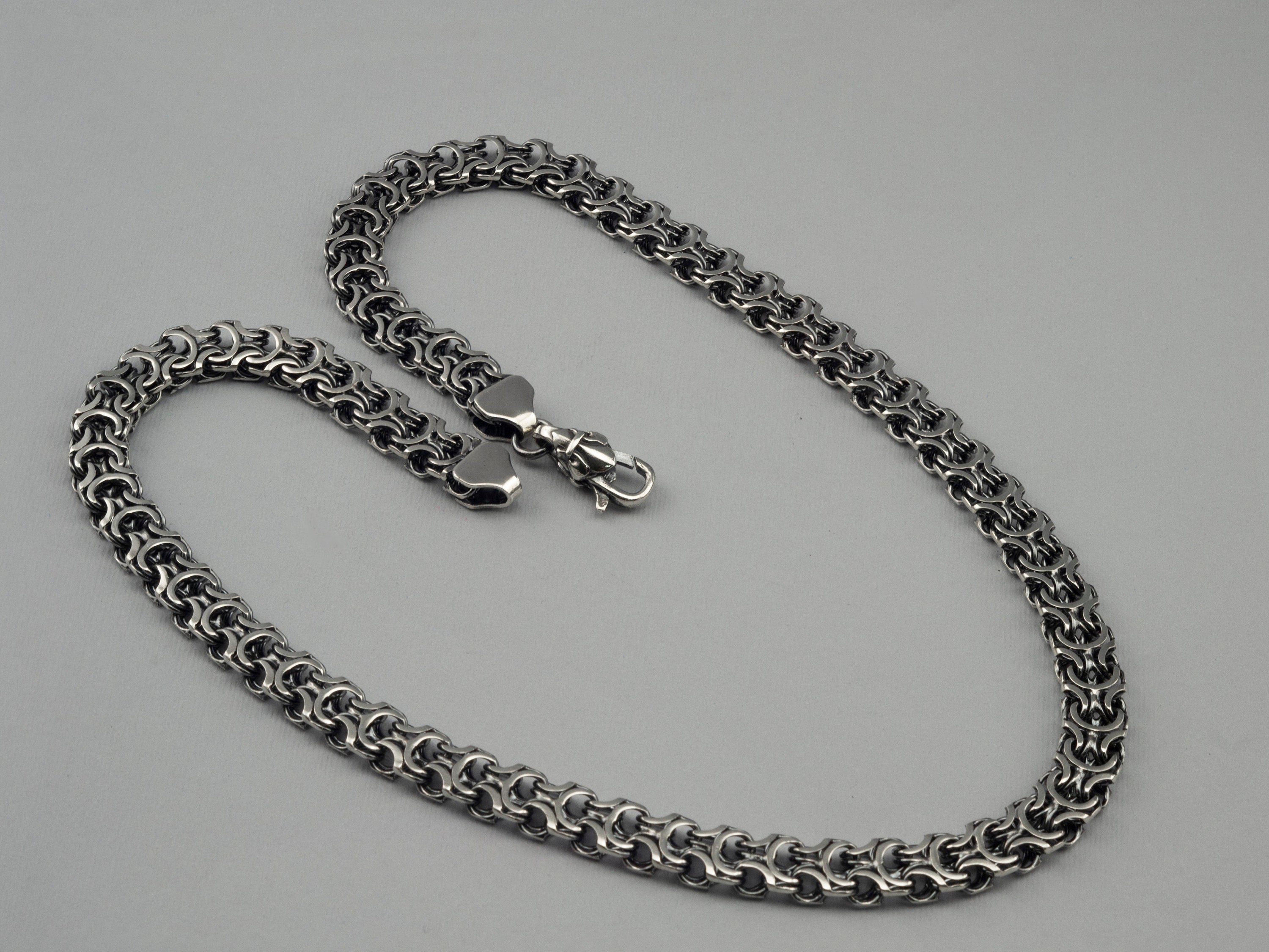 Close-up of the dense Kardinal weave on the heavy silver chain