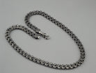 Close-up of the dense Kardinal weave on the heavy silver chain