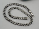 Kardinal chain laid in a loop showing the lobster clasp and end caps