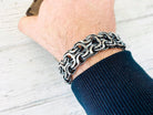 Kardinal heavy sterling silver biker bracelet worn on a man's wrist