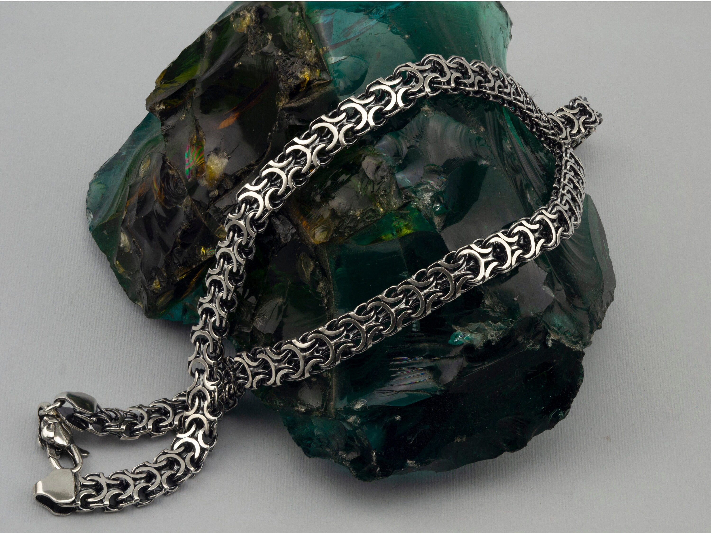 Heavy men's silver chain with oxidized Byzantine links, angled view