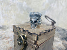 King of Shadow ring on a wooden box, angled view of the skull