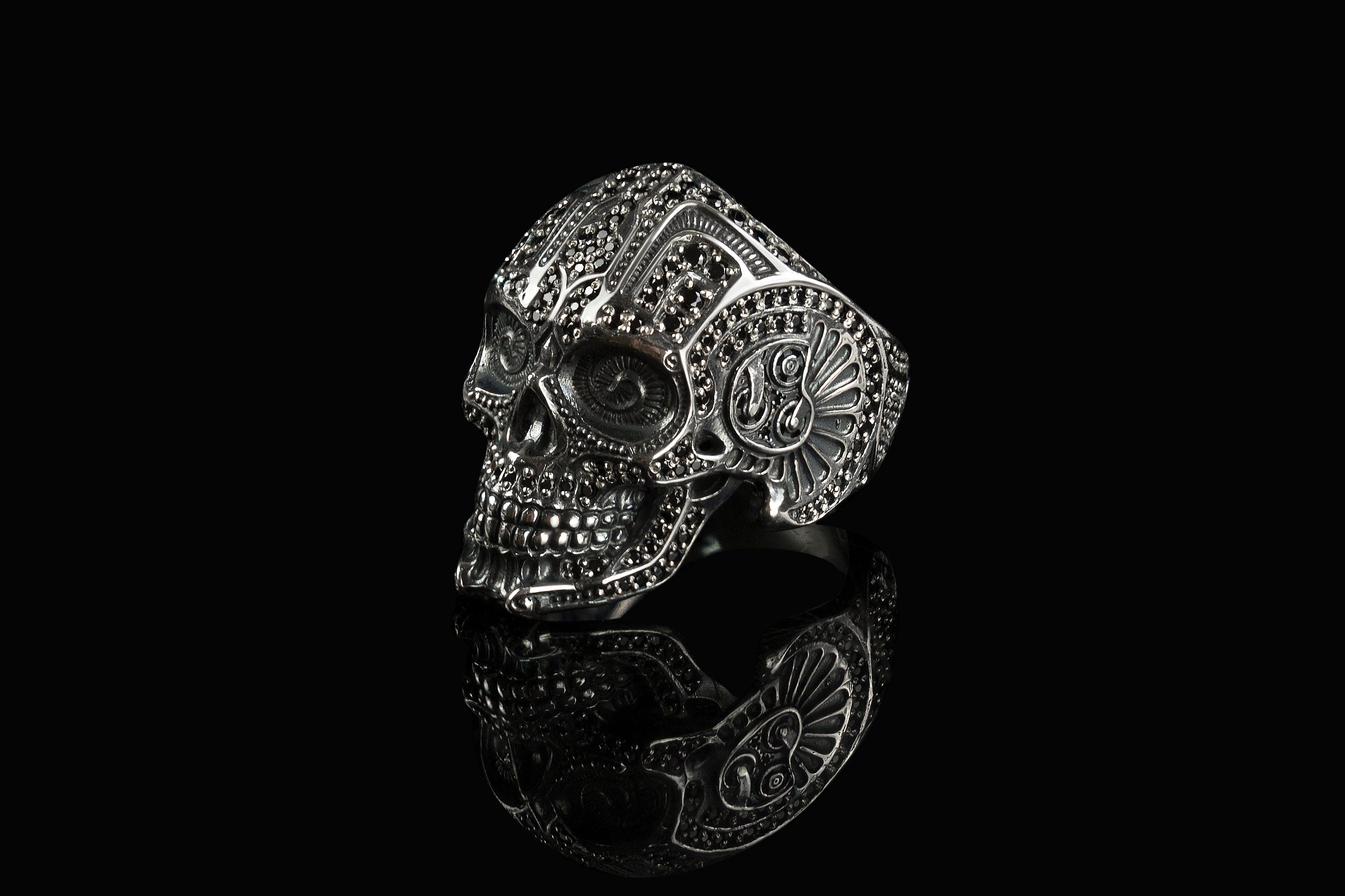 Mexican skull ring side view with ornamental cheek detail