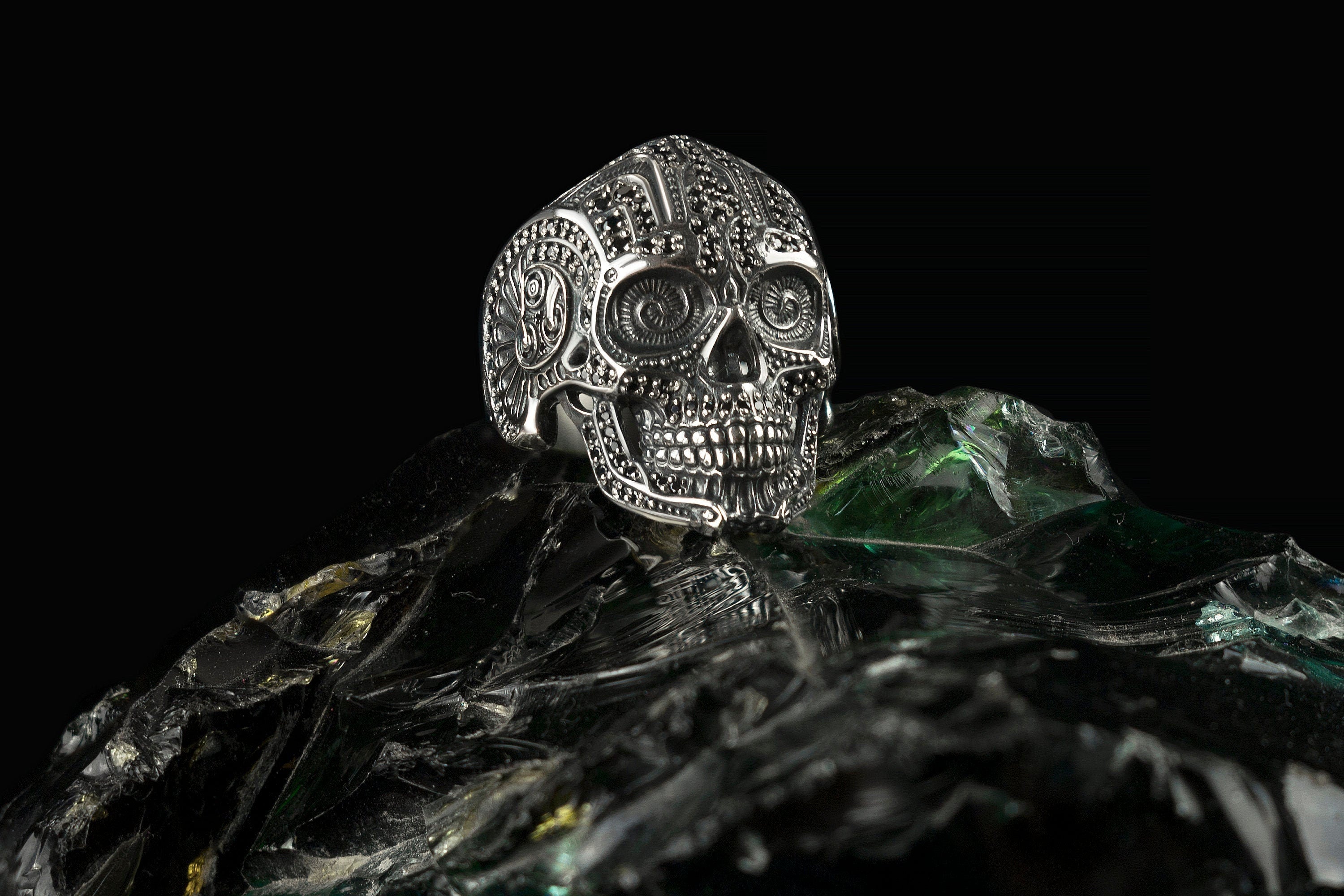 Mexican sugar skull sterling silver ring with black stones, angled view